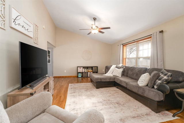 living room with lofted ceiling, light hardwood / wood-style floors, and ceiling fan