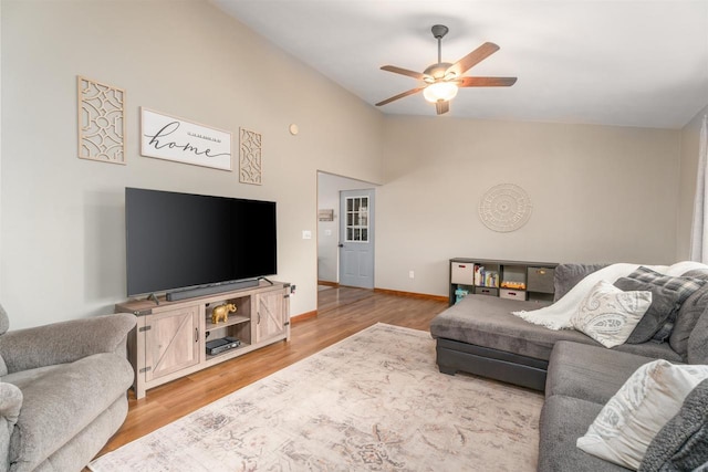 living room with lofted ceiling, light hardwood / wood-style floors, and ceiling fan