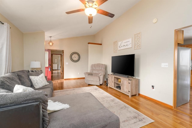 living room featuring lofted ceiling, hardwood / wood-style flooring, and ceiling fan