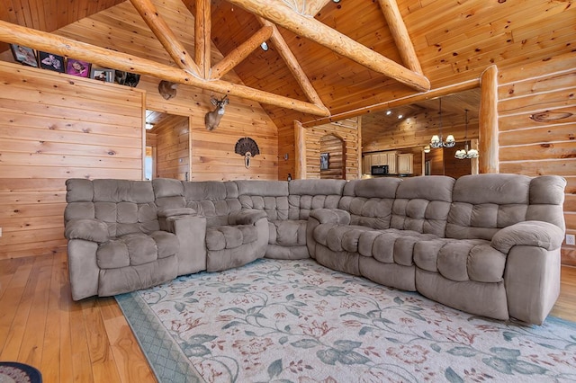 living room with an inviting chandelier, high vaulted ceiling, wood ceiling, light hardwood / wood-style floors, and beam ceiling