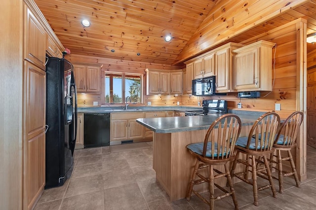 kitchen featuring black appliances, sink, a kitchen breakfast bar, wood ceiling, and kitchen peninsula