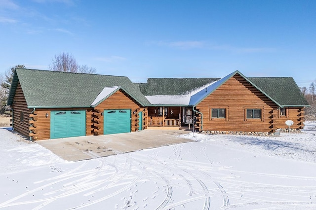 log cabin with a garage and covered porch