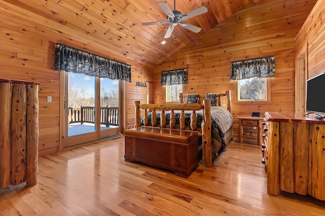 bedroom featuring wood ceiling, light wood-type flooring, vaulted ceiling, and wood walls