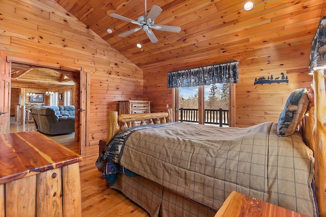 bedroom with wood walls, lofted ceiling, access to outside, wooden ceiling, and light wood-type flooring