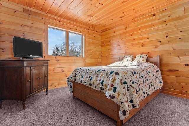 carpeted bedroom featuring wood ceiling and wood walls