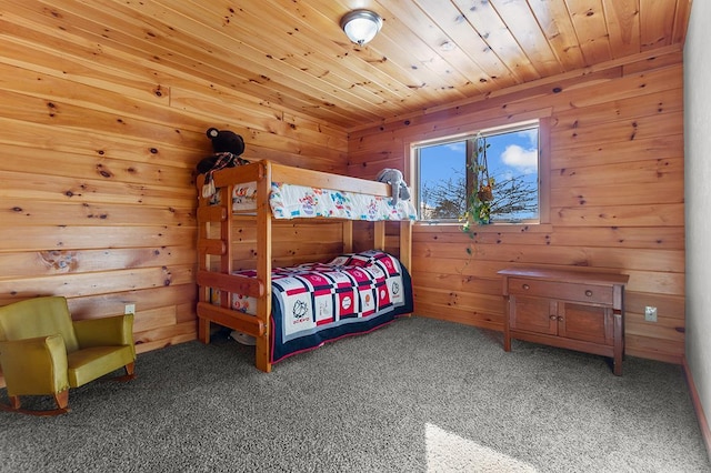 carpeted bedroom featuring wooden walls and wooden ceiling