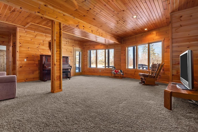 living area with wooden walls, plenty of natural light, carpet flooring, and wooden ceiling