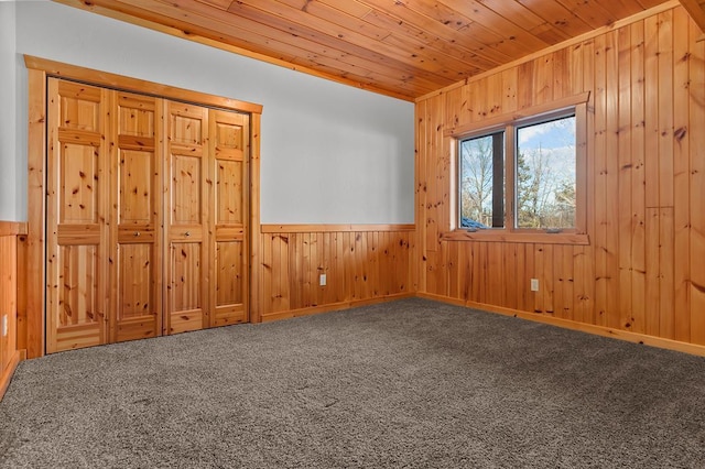 carpeted spare room with wood ceiling and ornamental molding