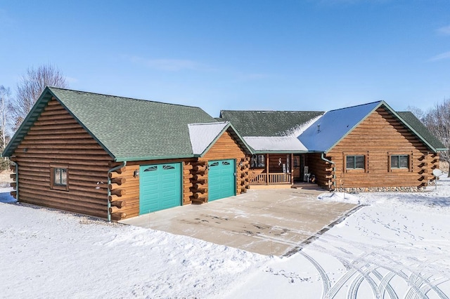 cabin with a garage and covered porch