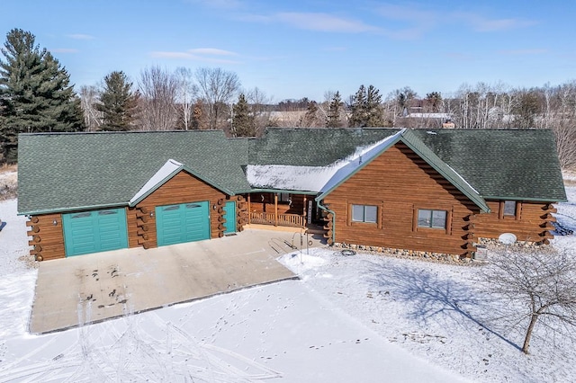 log-style house with a garage