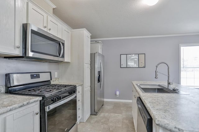 kitchen featuring white cabinetry, appliances with stainless steel finishes, sink, and crown molding