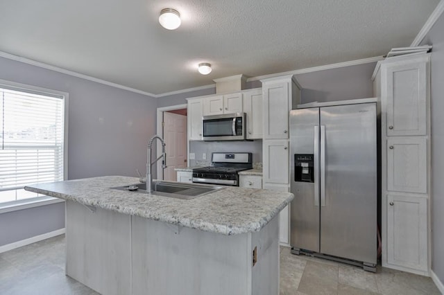 kitchen featuring white cabinetry, stainless steel appliances, sink, and an island with sink