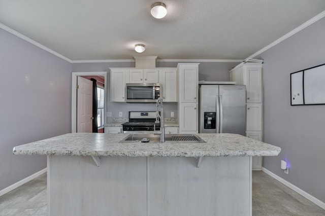 kitchen featuring white cabinetry, a kitchen bar, an island with sink, and appliances with stainless steel finishes