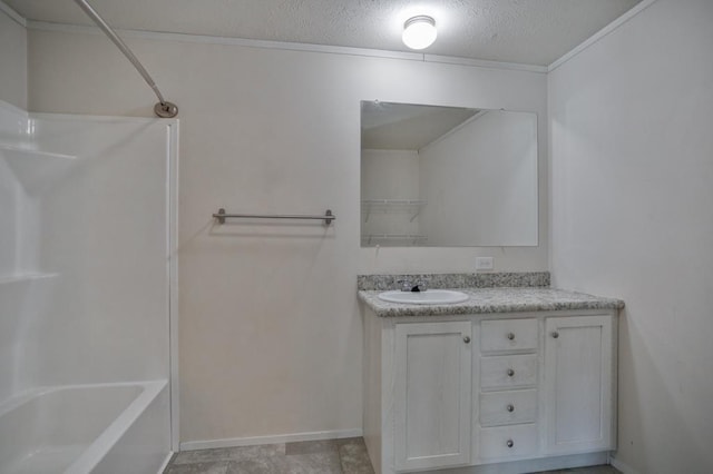 bathroom with crown molding, vanity, shower / washtub combination, and a textured ceiling