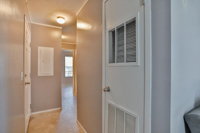 hall with crown molding and electric panel