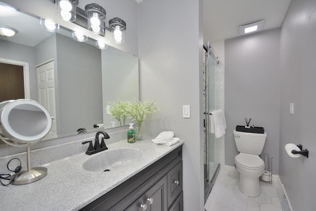 bathroom with tile patterned floors, vanity, toilet, and a shower with door