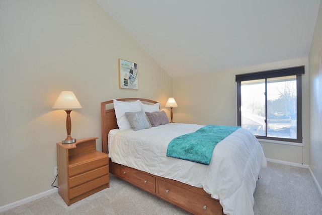 bedroom featuring vaulted ceiling and light colored carpet