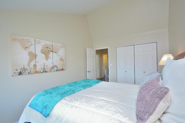 bedroom with vaulted ceiling and a closet