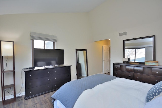 bedroom featuring lofted ceiling and hardwood / wood-style floors