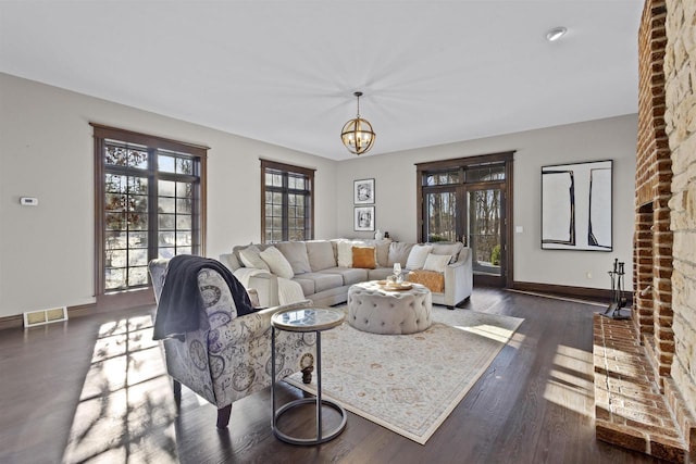 living room featuring dark wood-type flooring and a chandelier