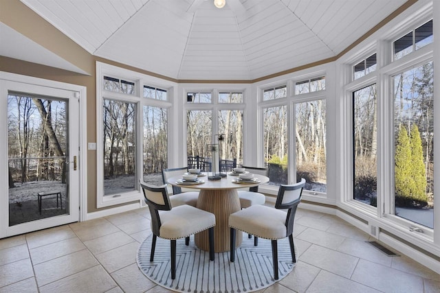 sunroom featuring vaulted ceiling