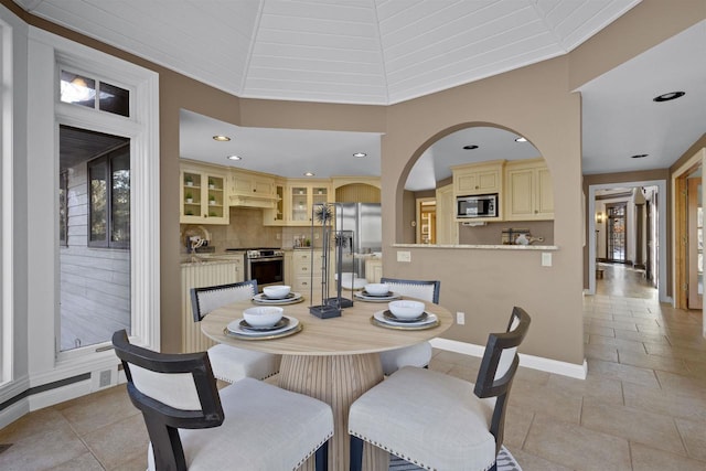 dining room featuring high vaulted ceiling