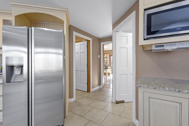 kitchen with light tile patterned floors and appliances with stainless steel finishes