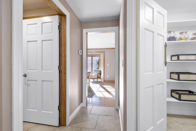 hall with light tile patterned floors