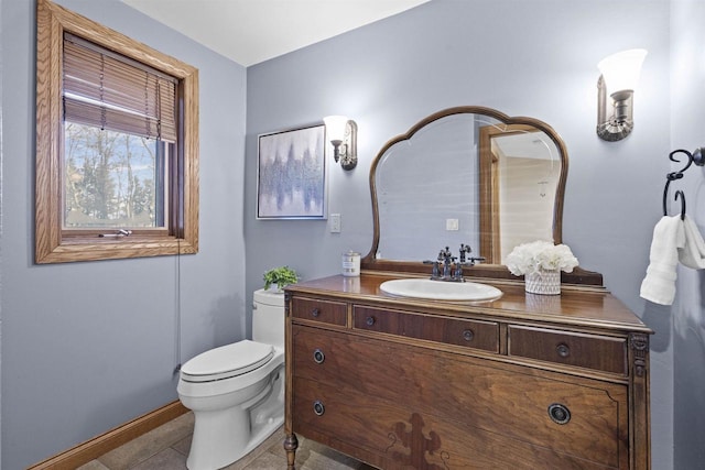 bathroom featuring vanity, tile patterned flooring, and toilet