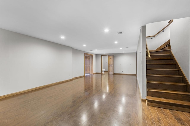 basement with hardwood / wood-style floors