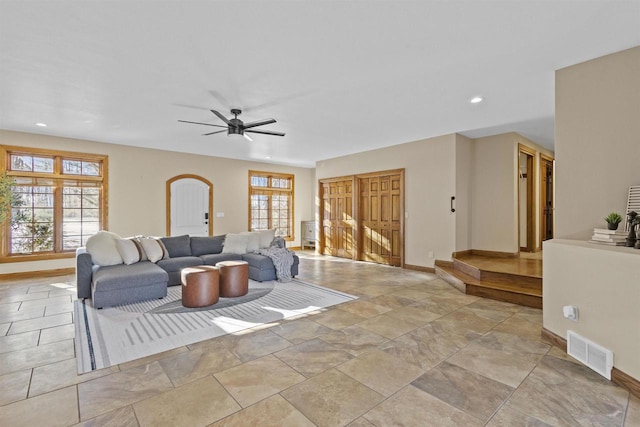 living room featuring plenty of natural light and ceiling fan