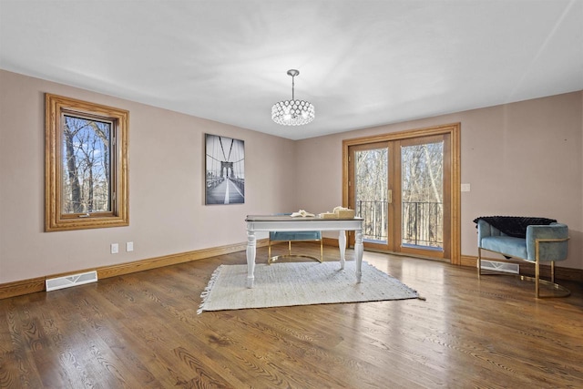 office area with an inviting chandelier and dark hardwood / wood-style flooring