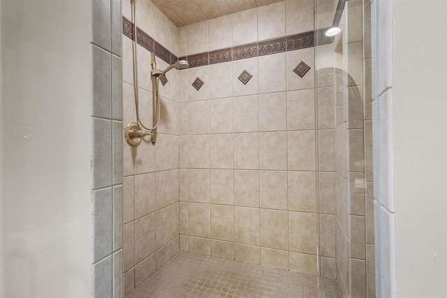 bathroom with a tile shower