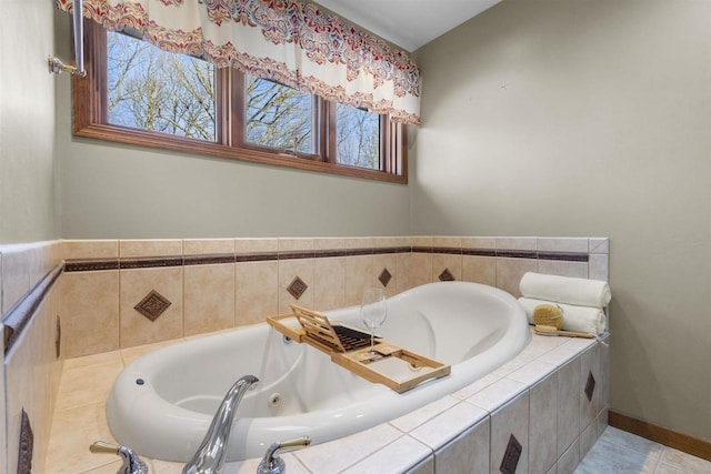 bathroom with tile patterned floors and tiled bath