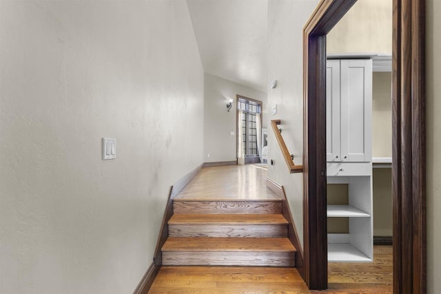 stairs featuring wood-type flooring