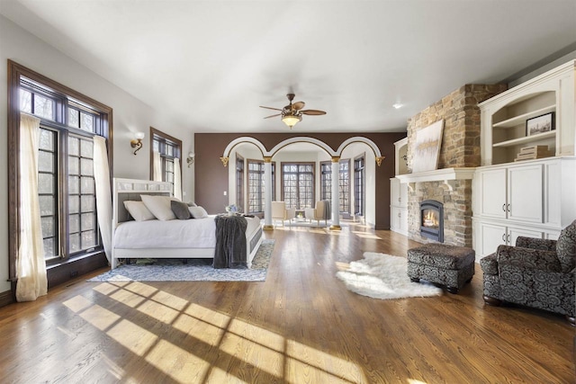 interior space featuring hardwood / wood-style flooring, ceiling fan, and multiple windows