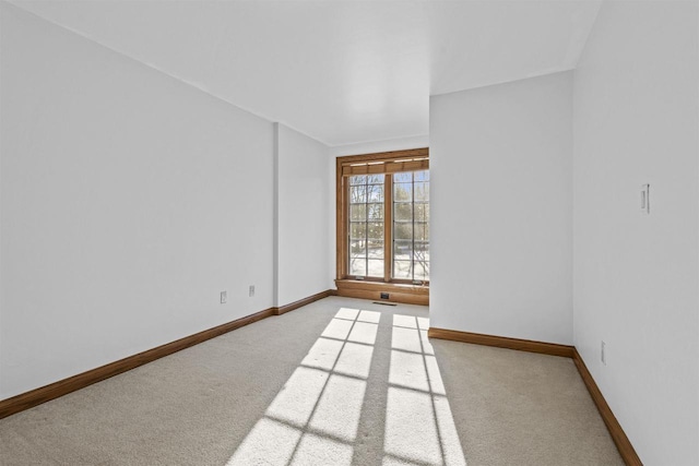 unfurnished room featuring light carpet