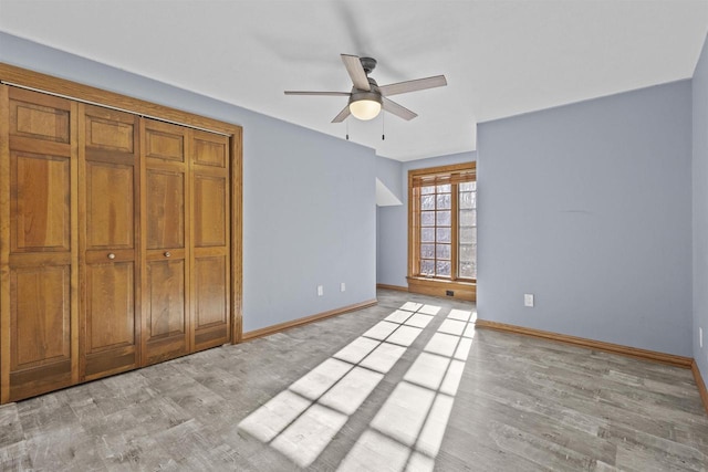 unfurnished bedroom with light hardwood / wood-style flooring, ceiling fan, and a closet