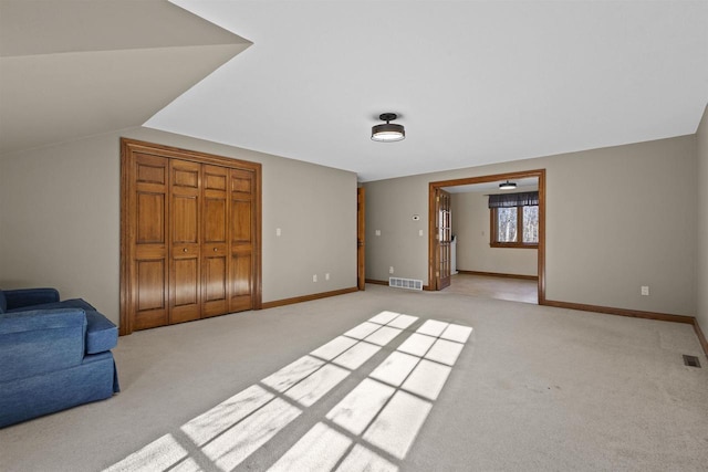 carpeted living room featuring vaulted ceiling