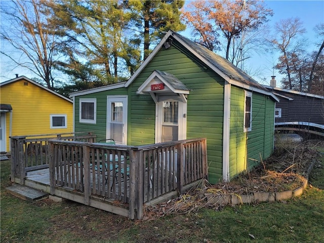 back of property with a wooden deck