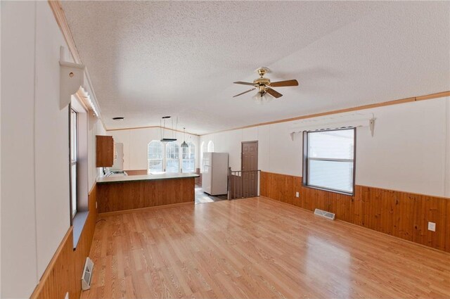 2218 10 1/8 Ave, Chetek, WI 54728 - unfurnished living room with plenty of natural light, light hardwood / wood-style floors, and a textured ceiling