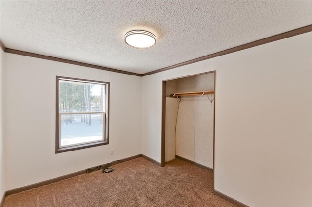2218 10 1/8 Ave, Chetek, WI 54728 - unfurnished bedroom featuring ornamental molding, carpet floors, a closet, and a textured ceiling