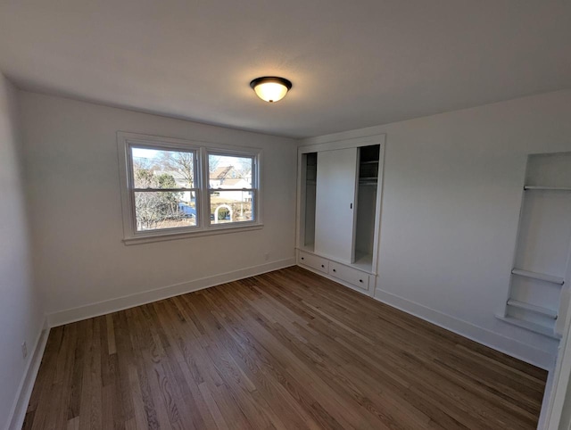 unfurnished bedroom featuring hardwood / wood-style flooring and a closet