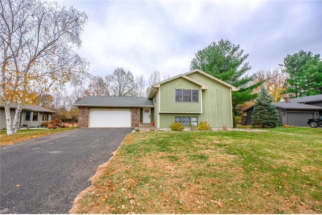 tri-level home featuring a garage and a front yard