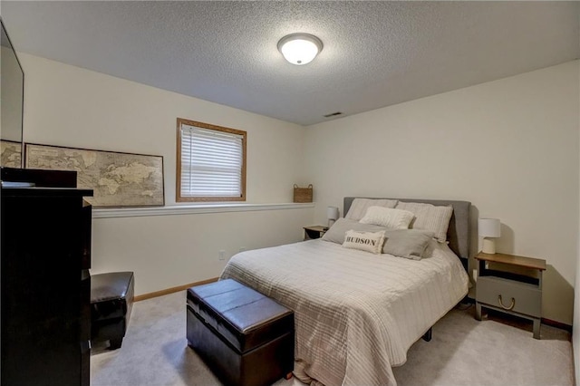 carpeted bedroom featuring a textured ceiling