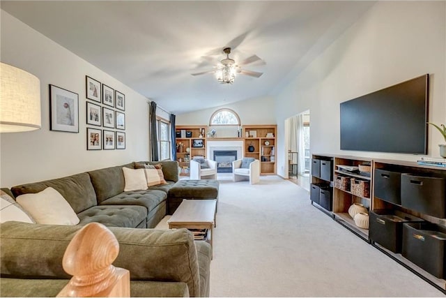 living room featuring vaulted ceiling, carpet floors, and ceiling fan