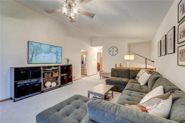 living room featuring ceiling fan, light colored carpet, and lofted ceiling