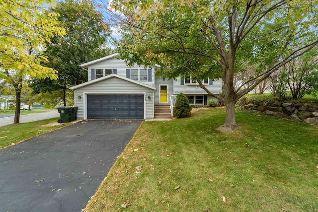 view of front of property with a garage and a front lawn