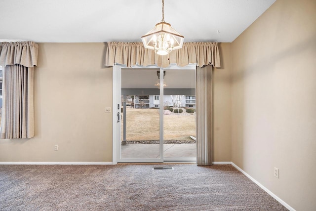 interior space featuring carpet floors and a notable chandelier