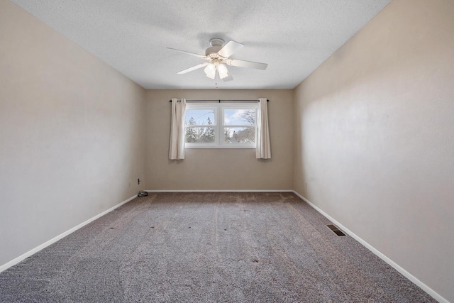 carpeted empty room with a textured ceiling and ceiling fan